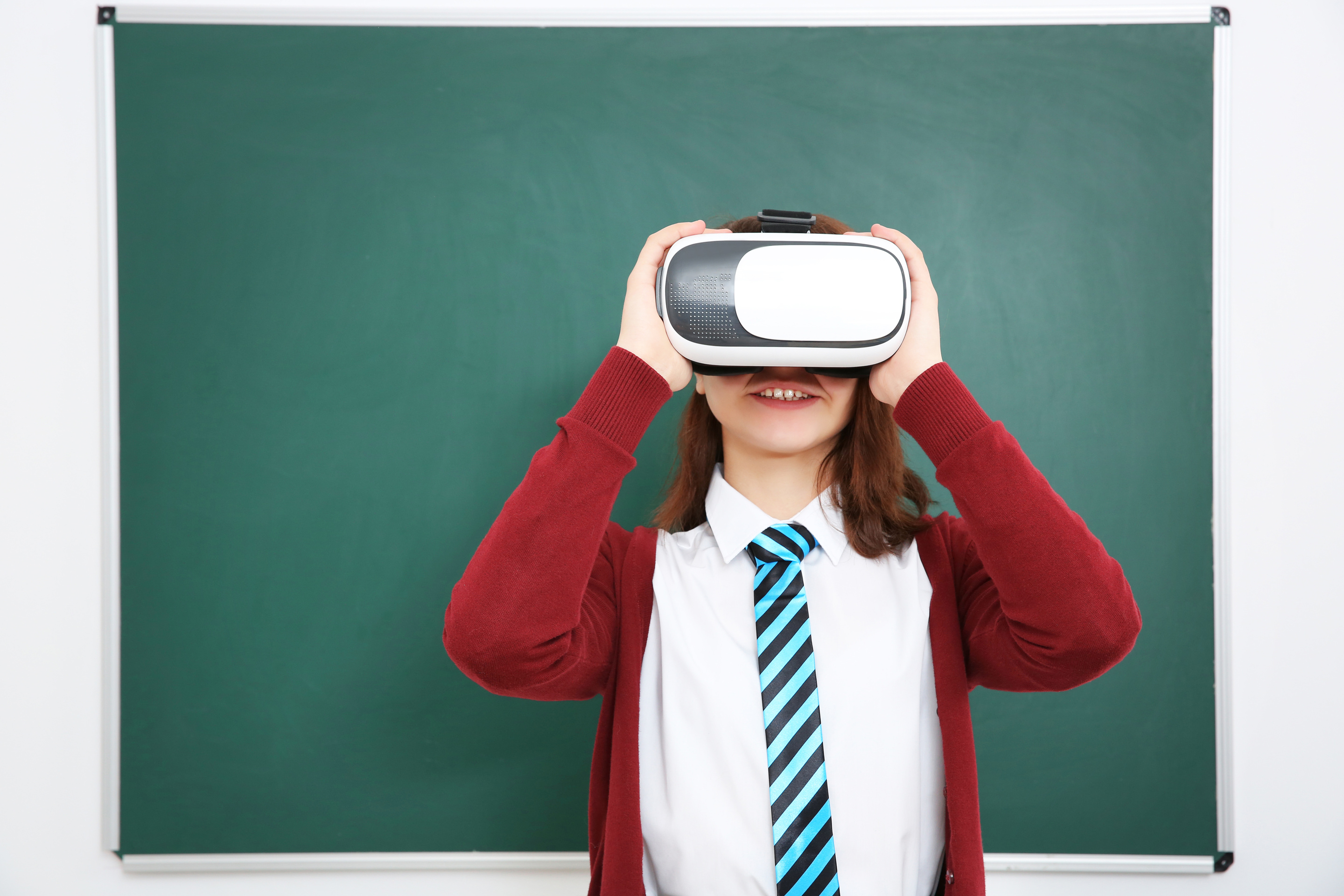 Schoolgirl with Virtual Reality Glasses in Classroom
